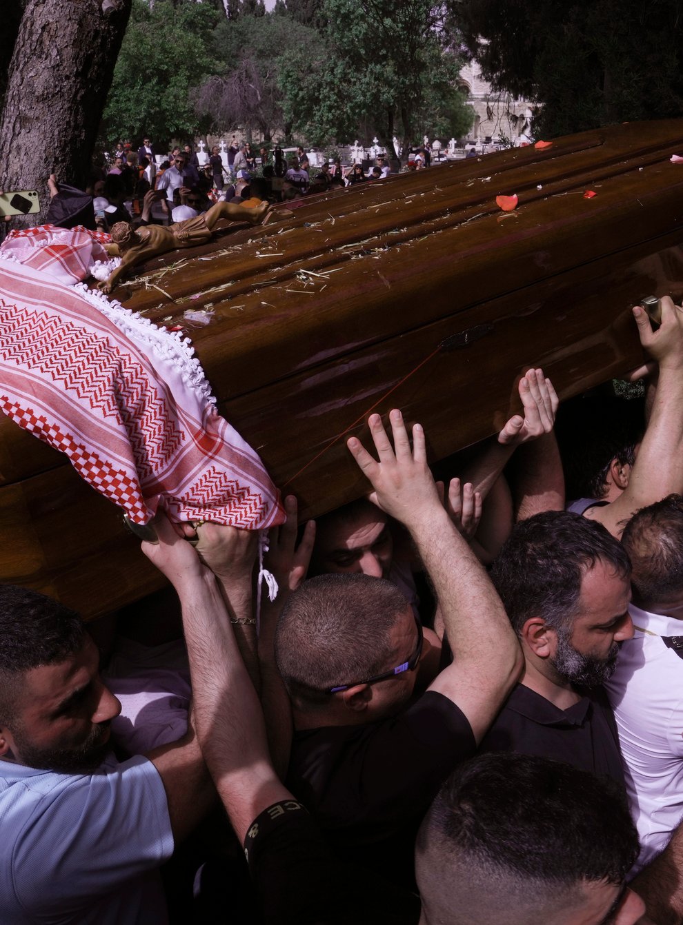 Mourners carry slain Al Jazeera veteran journalist Shireen Abu Akleh to her burial in Jerusalem (Mahmoud Illean/AP)