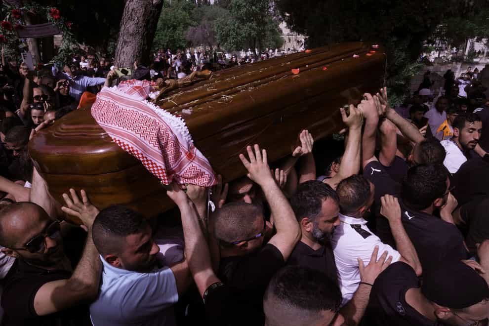 Mourners carry slain Al Jazeera veteran journalist Shireen Abu Akleh to her burial in Jerusalem (Mahmoud Illean/AP)