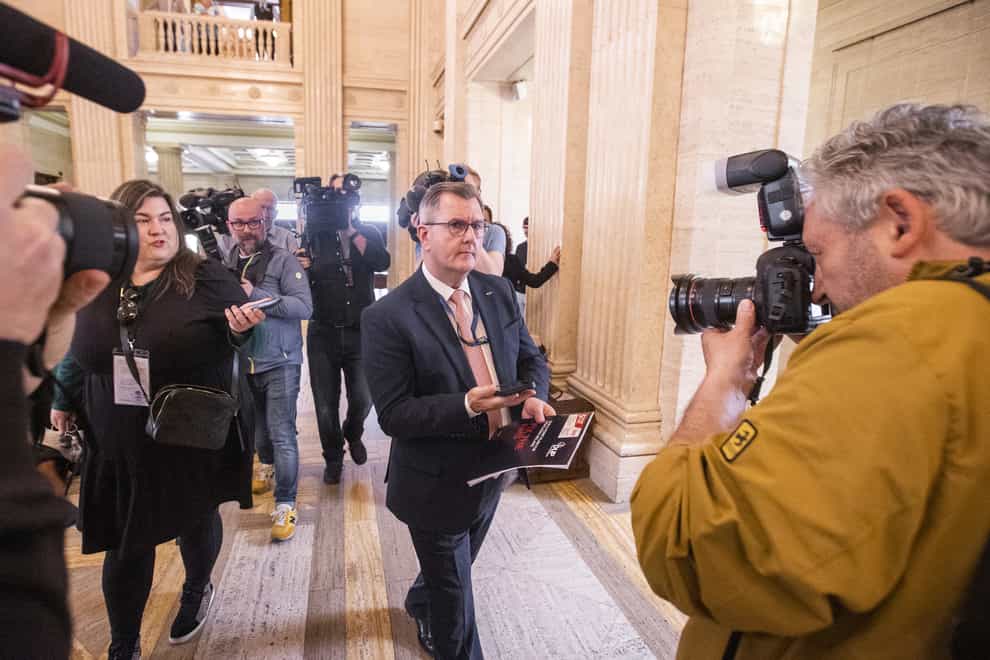 DUP leader Sir Jeffrey Donaldson avoids questions as he walks through the Great Hall of Parliament Buildings at Stormont (Liam McBurney/PA)