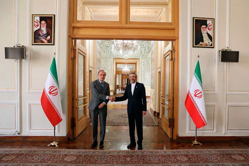 Enrique Mora, the European Union co-ordinator of talks to revive Iran’s nuclear accord with world powers, left, shakes hands with Iran’s top nuclear negotiator Ali Bagheri Kani, in Tehran (Iranian Foreign Ministry/AP)