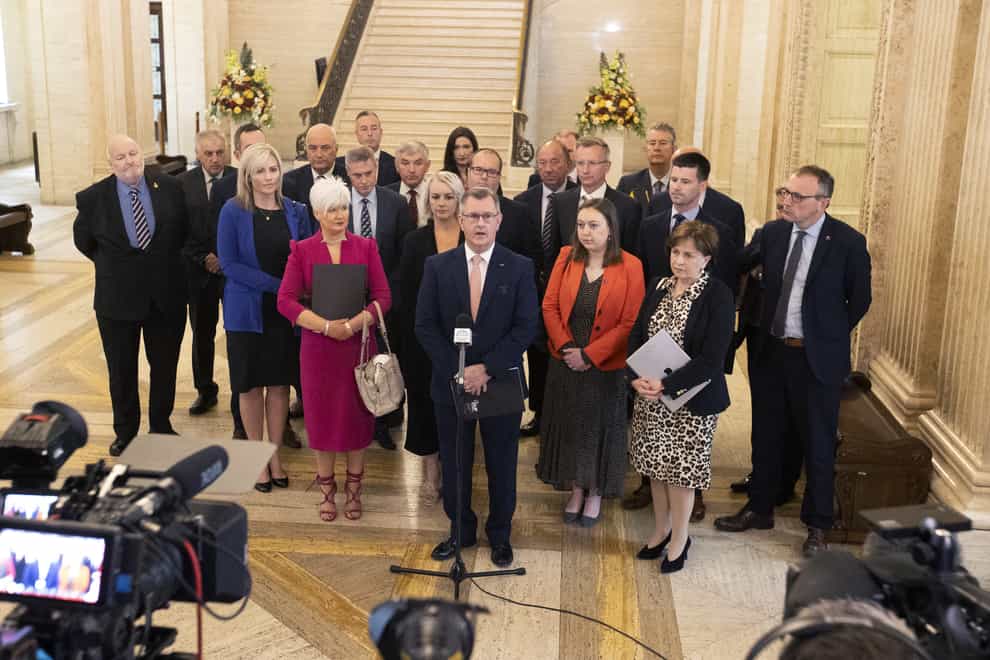 DUP Leader Sir Jeffrey Donaldson with party colleagues speaking in the Great Hall of Parliament Buildings at Stormont (Liam McBurney/PA)
