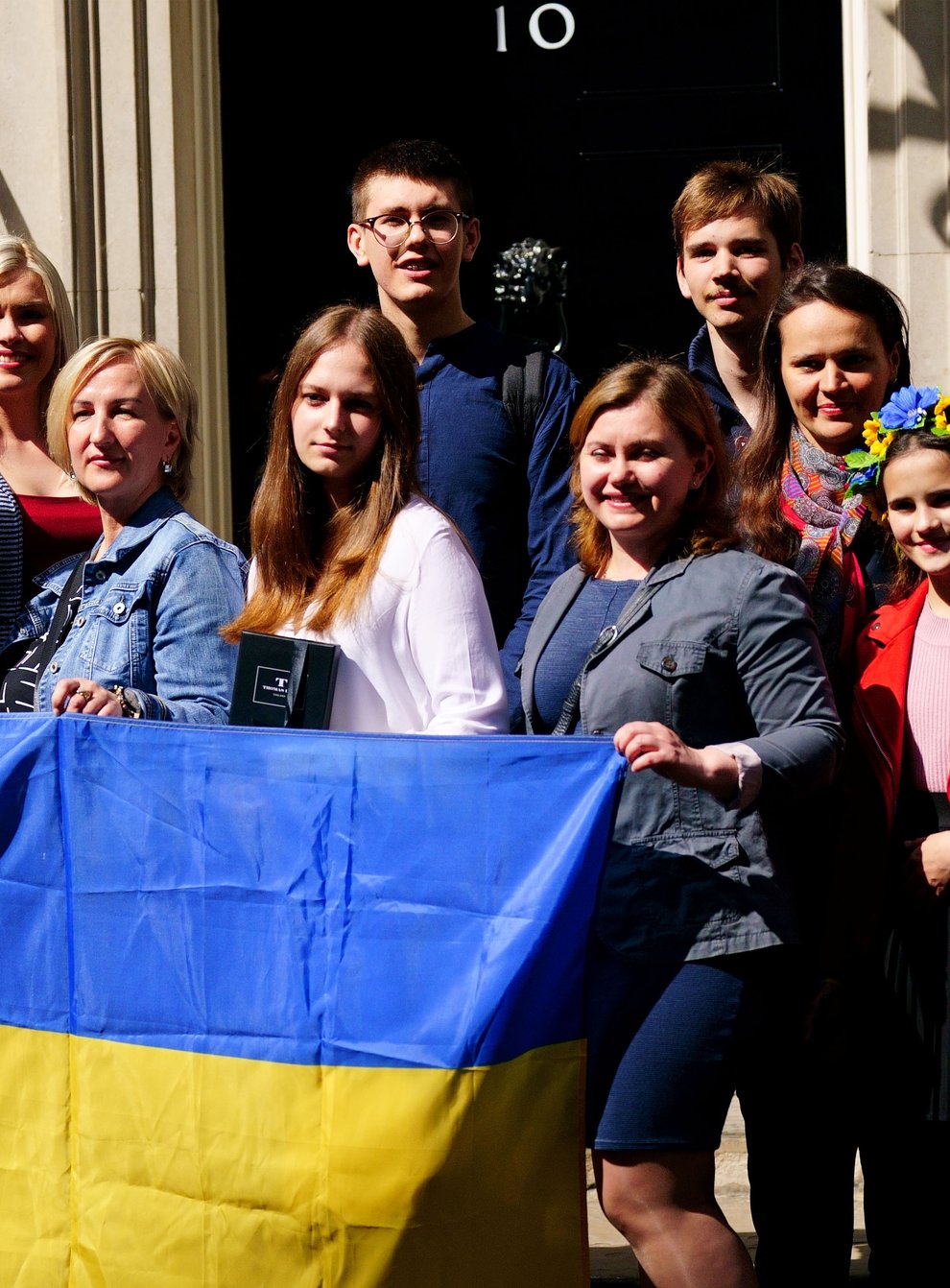 A number of Ukrainian families stand on the doorstep of 10 Downing Street after meeting Prime Minister Boris Johnson (Victoria Jones/PA)