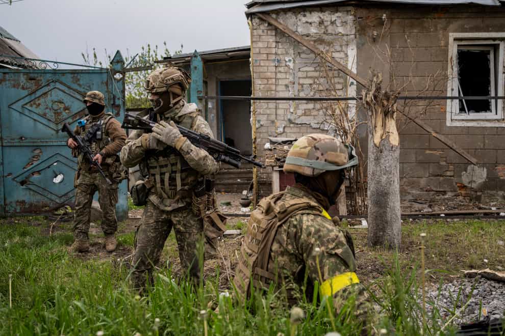 Ukrainian National Guard patrol during a reconnaissance mission in a recently retaken village on the outskirts of Kharkiv, east Ukraine (Bernat Armangue/AP)