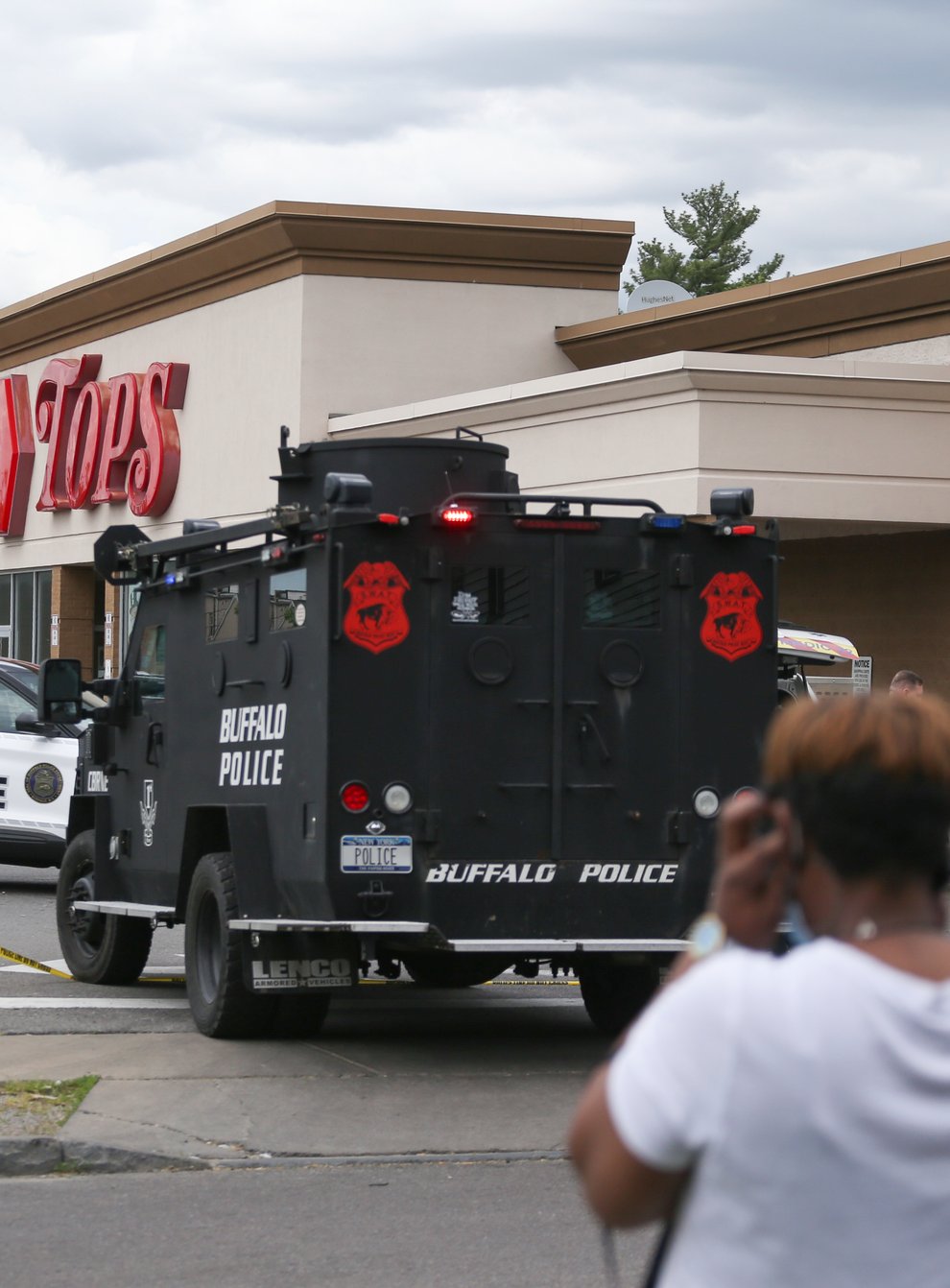 A crowd gathers as police investigate after a shooting at a supermarket in Buffalo (Joshua Bessex/AP)