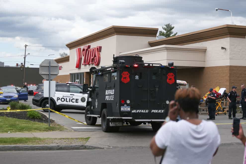 A crowd gathers as police investigate after a shooting at a supermarket in Buffalo (Joshua Bessex/AP)