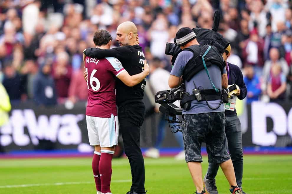 Manchester City manager Pep Guardiola hugs West Ham’s Mark Noble (Adam Davy/PA)