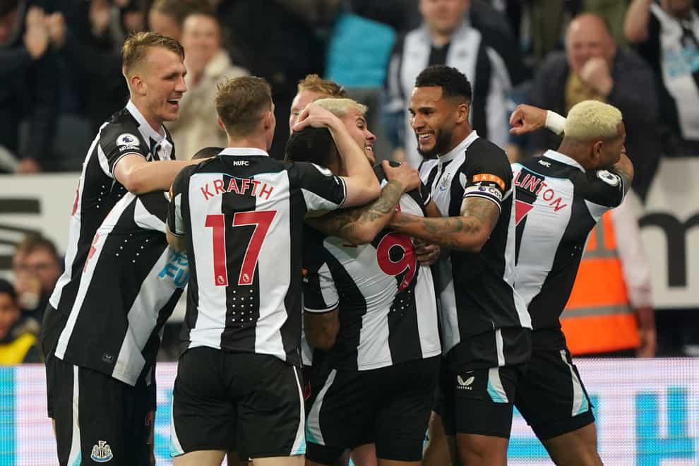Newcastle players celebrate their first goal (Owen Humphreys/PA)