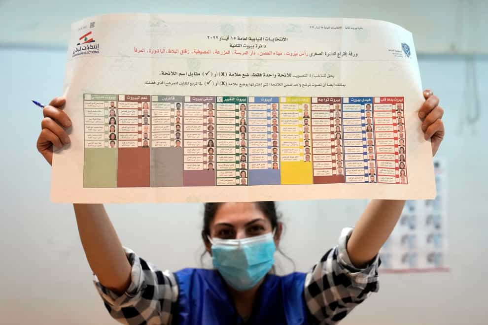 An election worker shows a ballot to parliamentary candidates representatives, after the close of a polling station, in Beirut, Lebanon (Hussein Malla/AP)