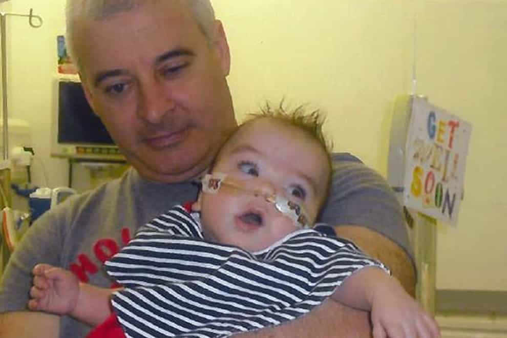 Undated family handout file photo issued by PSNI of fatally shot Kevin McGuigan with his grandson Ollie, who was in hospital in 2011, as a woman has been arrested by police investigating his murder.