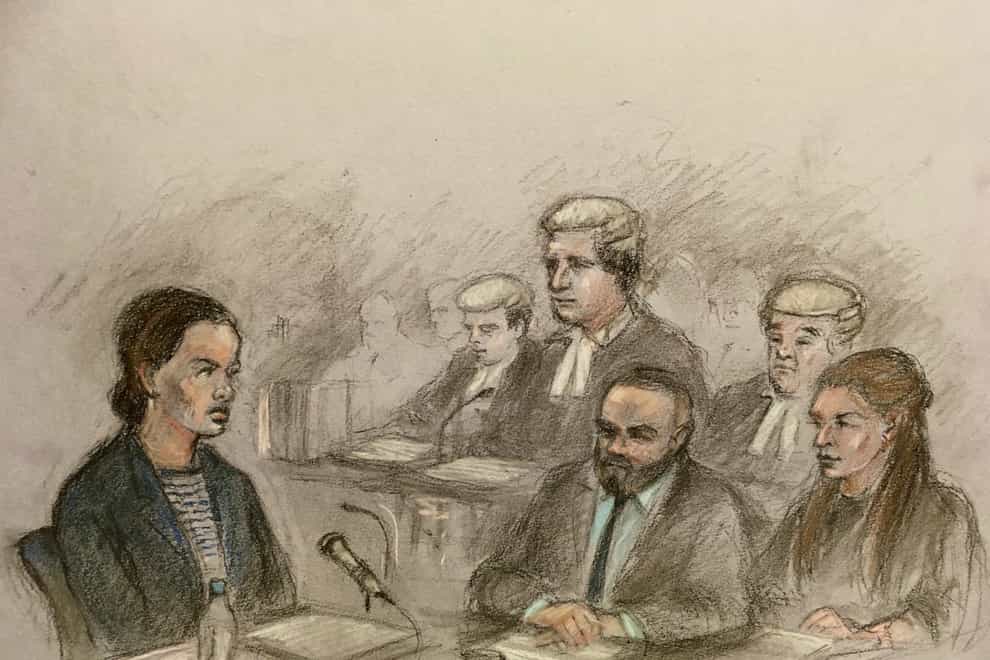 Court sketch of Rebekah Vardy giving evidence in the ‘Wagatha Christie’ trial as Coleen Rooney and her husband Wayne watch on (Elizabeth Cook/PA)