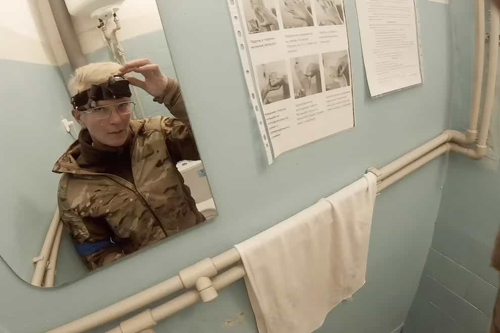 Yuliia Paievska, known as Taira, looks in the mirror and turns off her camera in Mariupol, Ukraine (Yuliia Paievska via AP)