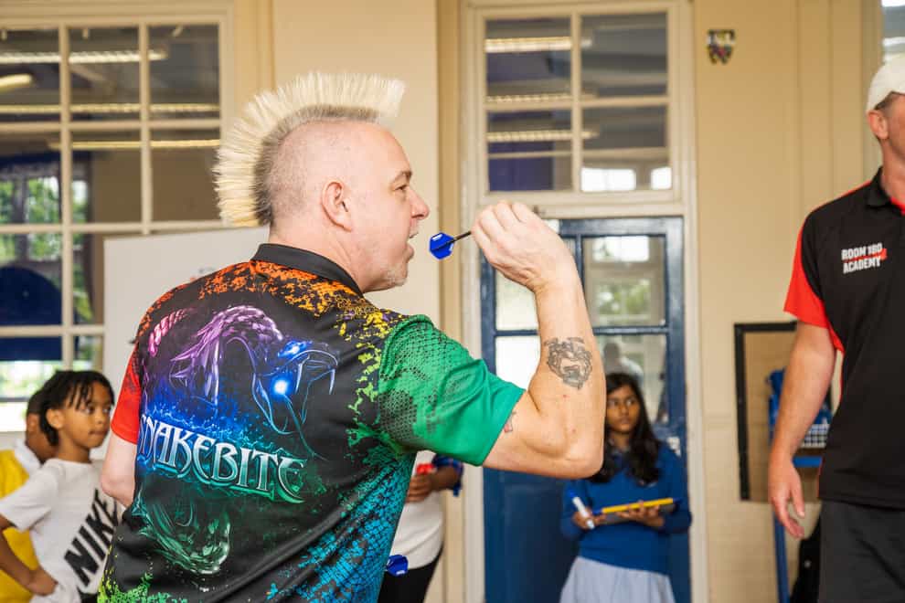 Peter Wright has revealed how darts helped him overcome numeracy problems (PDC handout/PA)