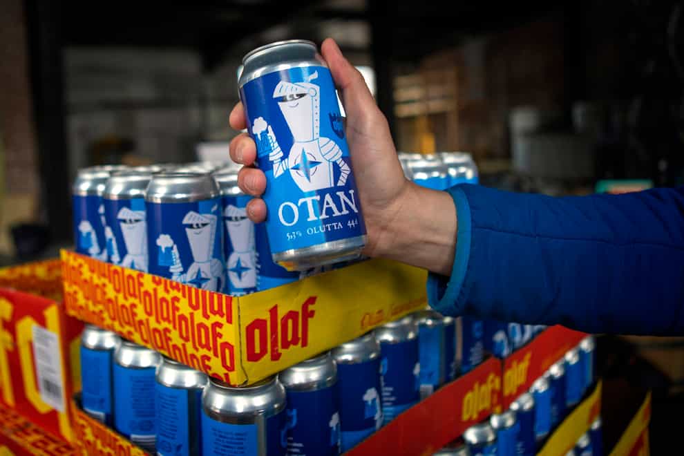 Beer cans inspired by the Nato logo by Olaf Brewing Company are displayed in Savonlinna, eastern Finland (Soila Puurtinen/Lehtikuva via AP)