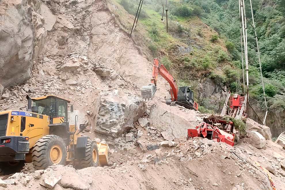 Diggers work to clear the site where an under construction tunnel collapsed in Ramban district, in Indian-controlled Kashmir (Jammu and Kashmir Government’s Department of Disaster Management via AP)