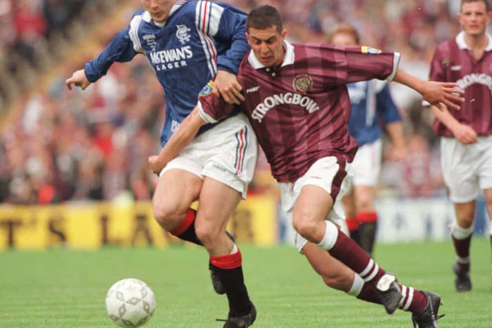 Rangers hero Brian Laudrup fends off Allan McManus in the 1996 final (PA)