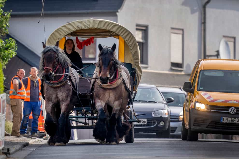Stephanie Kirchner steers her carriage on the main road through her home town in Germany (Michael Probst/AP)