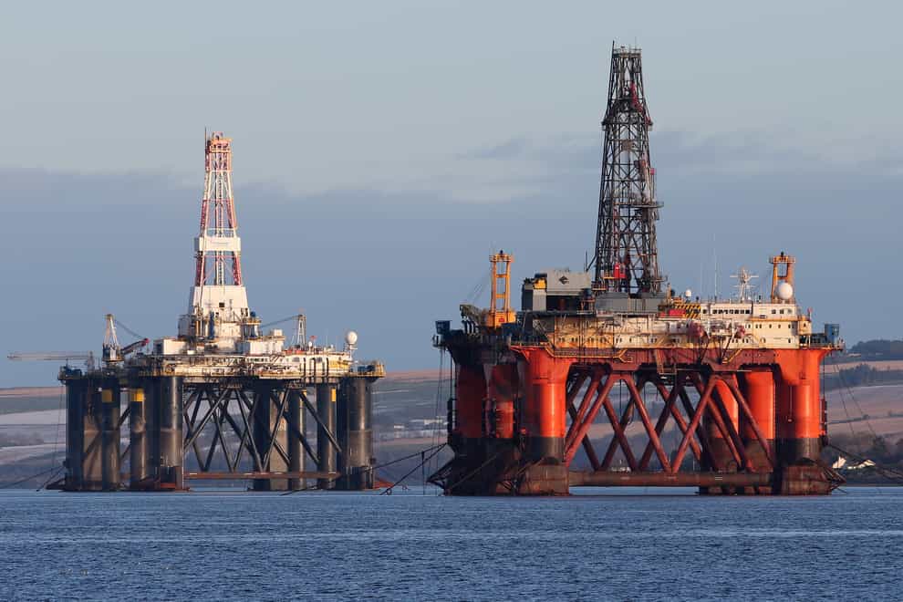 An oil platform stands amongst other rigs which have been left in the Cromarty Firth near Invergordon in the Highlands of Scotland (Andrew Milligan/PA)
