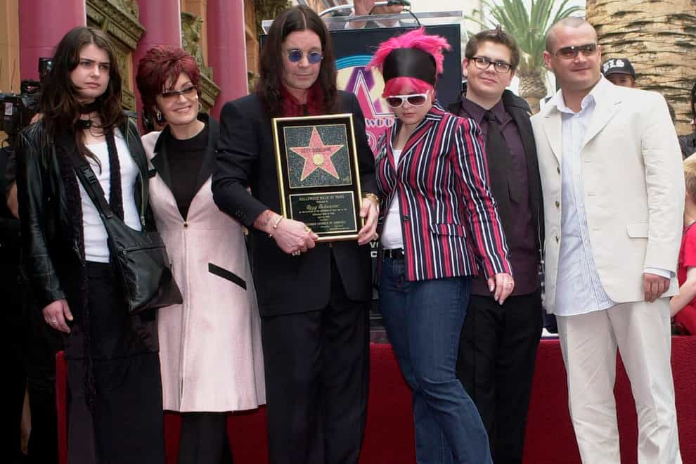 Ozzy Osbourne, centre, poses with his family, from left, daughter Aimee, wife Sharon, daughter Kelly, son Jack and his son Louis, after he was honoured with a star on the Hollywood Walk of Fame in Los Angeles in 2002 (Nick Ut/AP)
