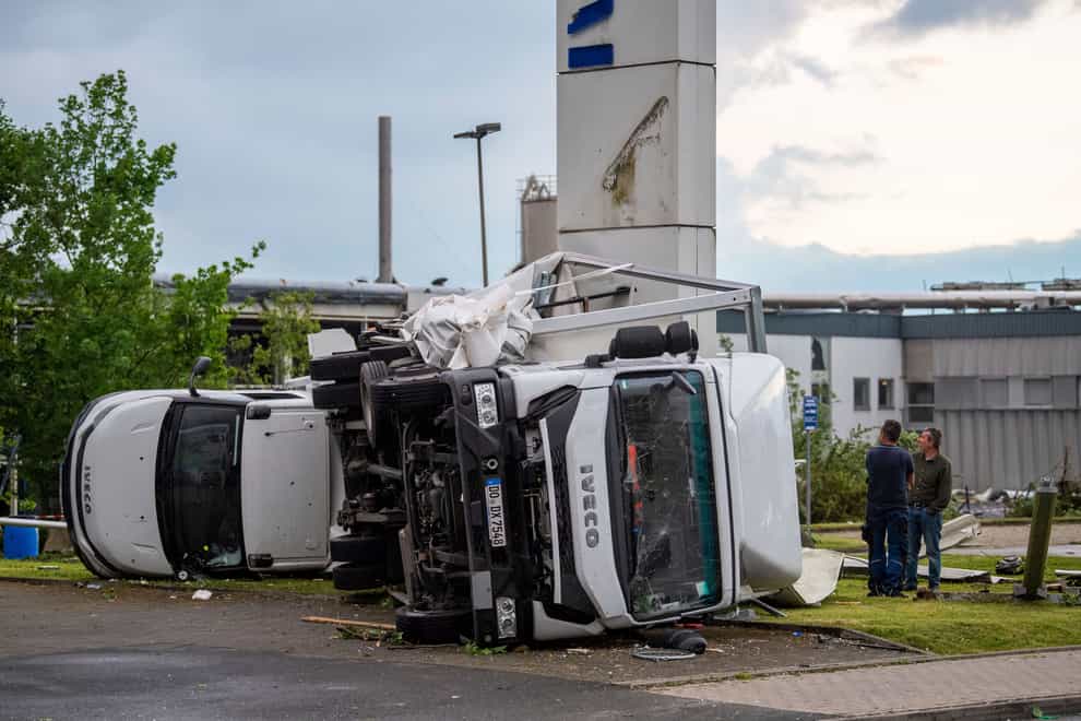 Two trucks overturned after a storm in Paderborn, Germany (Lino Mirgeler/dpa via AP)