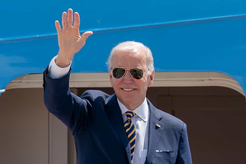 President Joe Biden waves as he boards Air Force One (Gemunu Amarasinghe/AP)