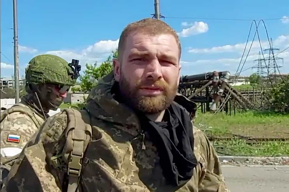 In this photo taken from video released by the Russian defence ministry on Saturday May 21 2022, Serhiy Volynskyy, nicknamed Volyna, commander of Ukraine’s 36th Special Marine Brigade of Ukraine’s Naval Forces lines up to be checked as he leaves the besieged Azovstal steel plant in Mariupol, in territory under the government of the Donetsk People’s Republic, eastern Ukraine (Russian Defense Ministry Press Service/AP)
