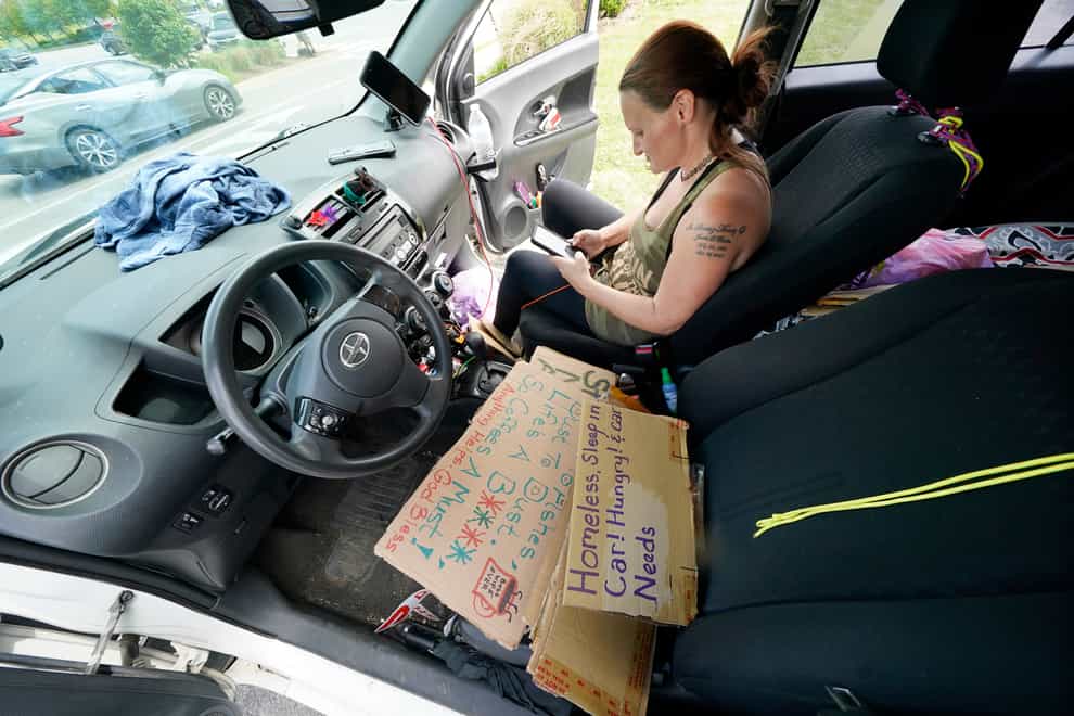Miranda Atnip sits in her car in a car park (Mark Humphrey/AP)