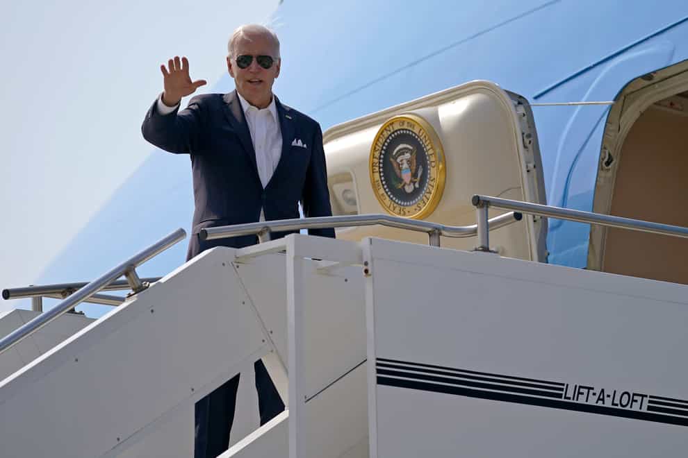 Joe Biden waves from Air Force One on his arrival in Japan (Evan Vucci/AP)