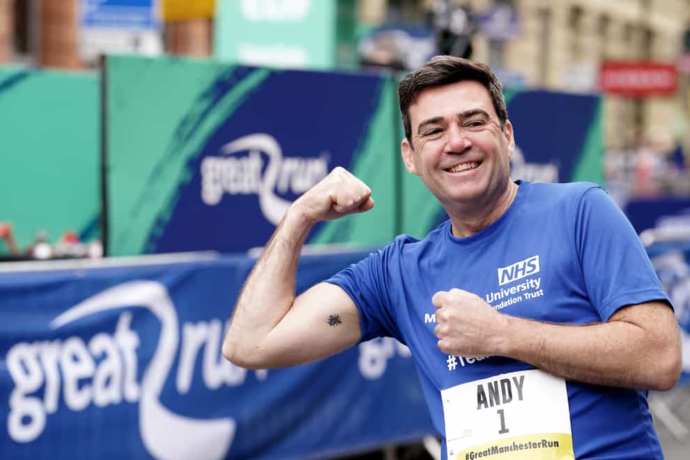 Andy Burnham shows his Manchester worker bee tattoo ahead of the Great Manchester Run (Martin Rickett/PA)