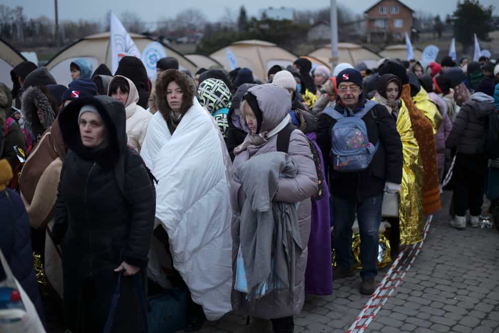 Refugees waiting for transportation after fleeing from Ukraine and arriving at the border crossing in Medyka, Poland, in March (Markus Schreiber/AP)