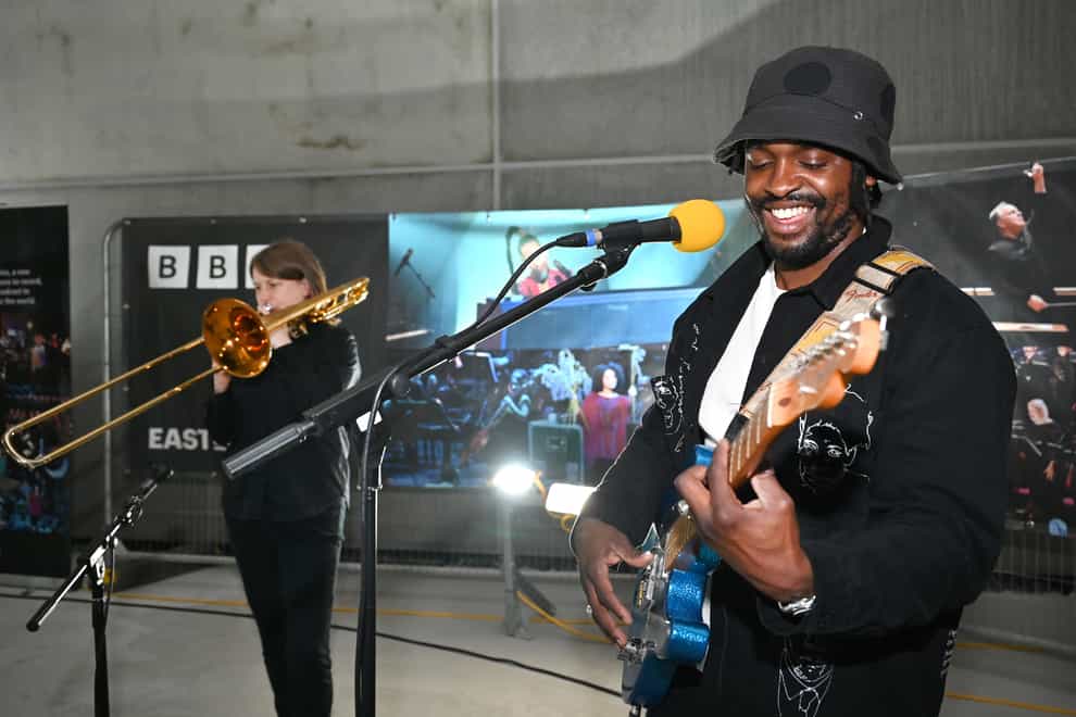 Hak Baker and Helen Vollam celebrate the topping out of the BBC’s new music studios at East Bank, in the first live performance (Mark Allan/BBC/PA)