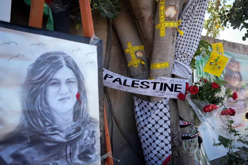 A memorial at the site where Palestinian-American Al-Jazeera journalist Shireen Abu Akleh was shot and killed in the West Bank city of Jenin (AP)