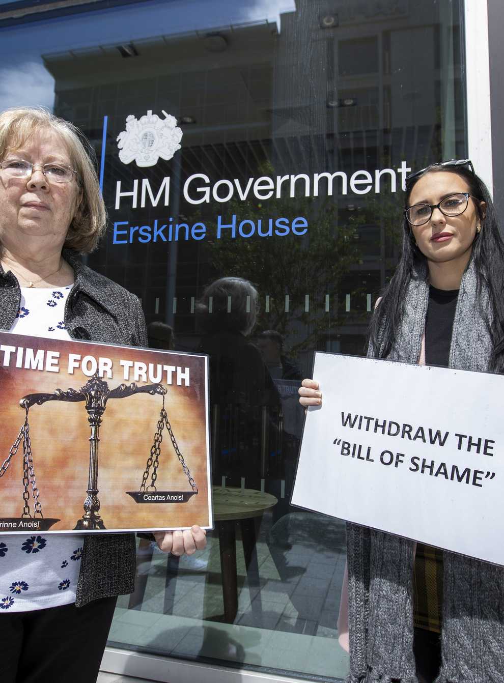 Marian Walsh and Natasha Butler protest at the Northern Ireland Office UK Government Hub at Erskine House in Belfast (PA)