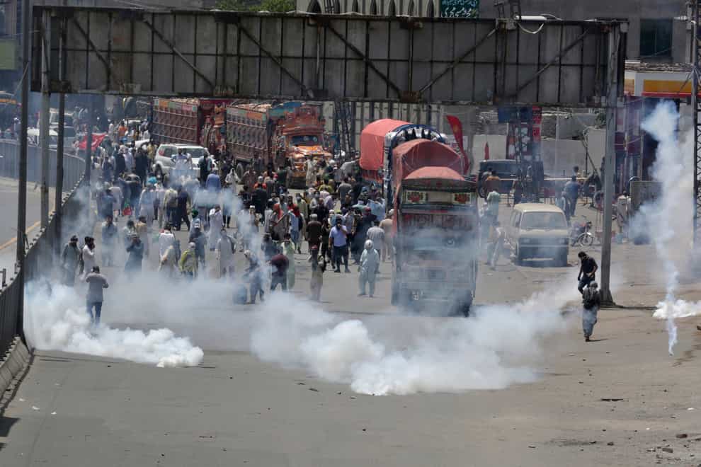Police fire tear gas to disperse supporters of Pakistan’s key opposition party marching towards Islamabad (KM Chaudary/AP)