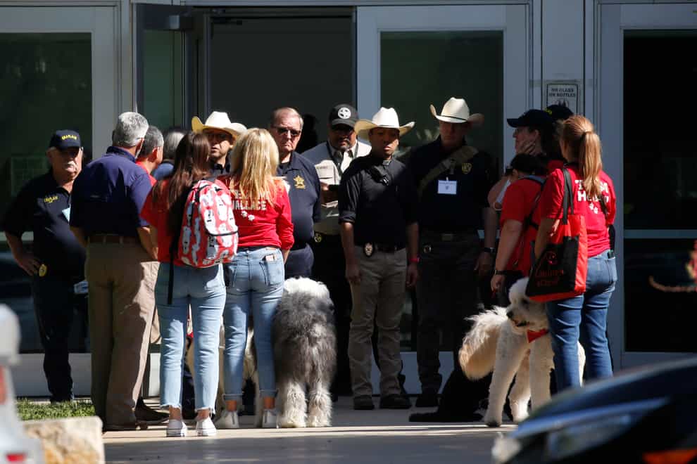Police and members of the Brooke Army Medical Centre Therapy Dogs unit gather outside of the Civic Centre in Uvalde, Texas (Dario Lopez-Mills/AP)