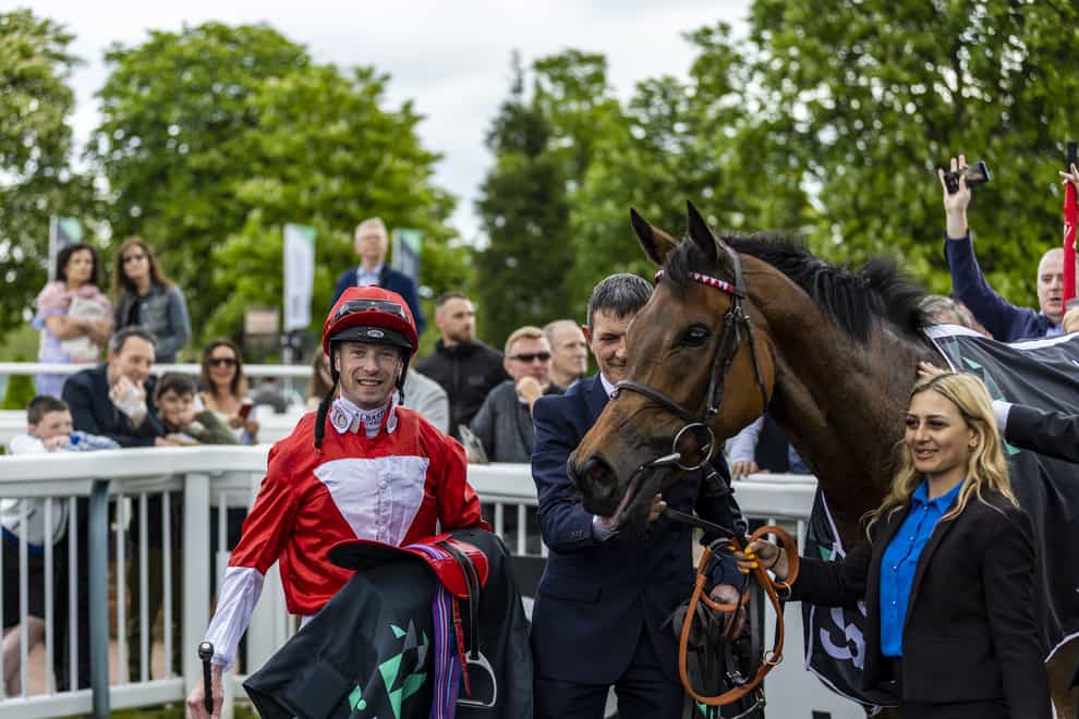 Jockey Jack Mitchell in the winners enclosure after winning on Rogue Millennium in the SBK Oaks Trial Fillies’ Stakes at Lingfield Park Racecourse (Steven Paston/PA)