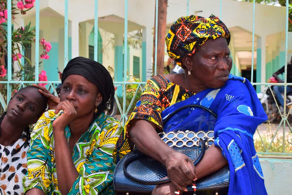 Relatives sit outside the Abdoul Aziz Sy Dabakh hospital waiting for news (AP Photo/Cheik Sy)