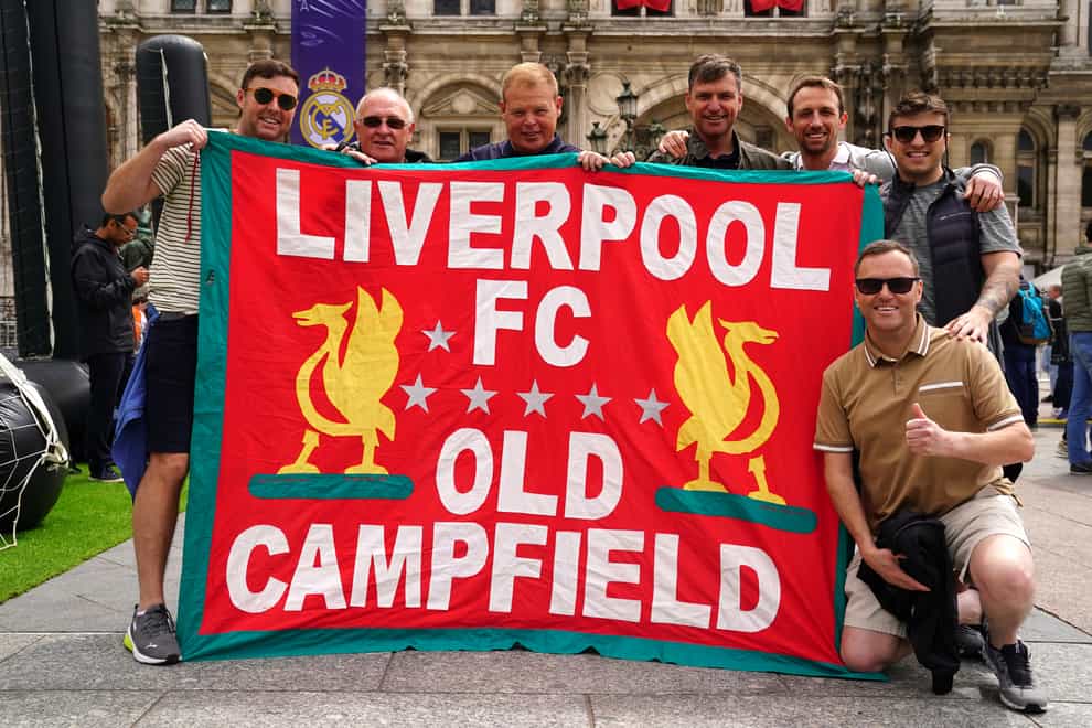 Liverpool fans hold a flag of support at the Trophy Experience at The Place de l’Hotel de Ville in Paris ahead of Saturday’s UEFA Champions League Final at the Stade de France, Paris (Adam Davy/PA)