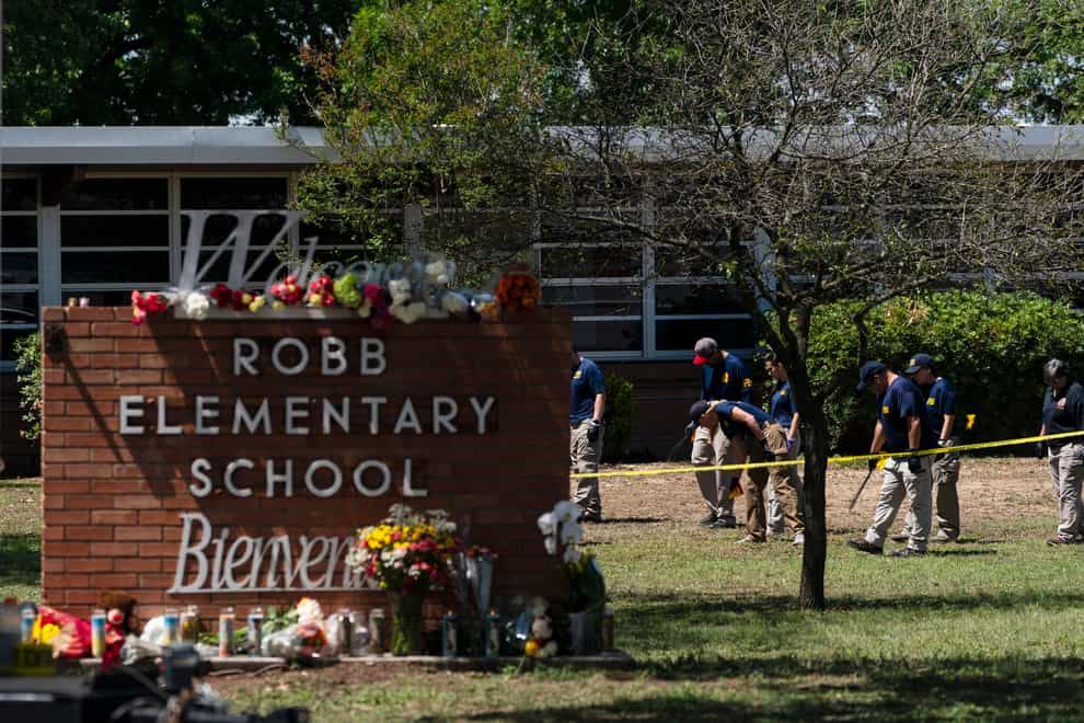 Investigators search for evidence outside Robb Elementary School in Uvalde, Texas (Jae C Hong/AP)