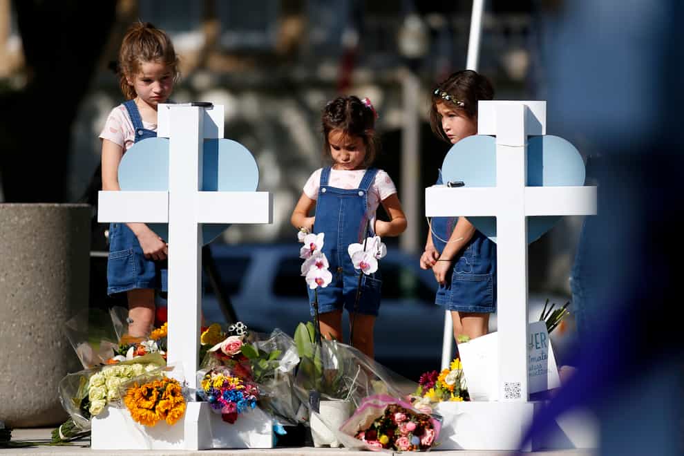 Children pay their respects at a memorial site for the victims (Dario Lopez-Mills/AP)