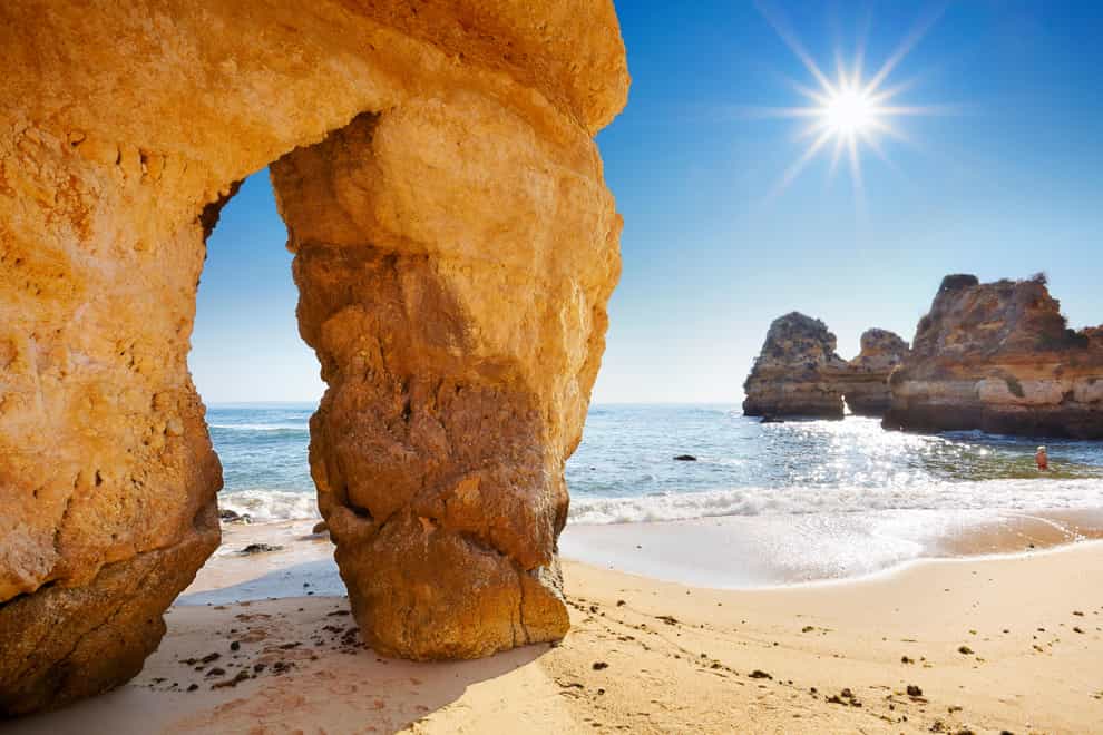 Landscape with the sun, Algarve beach near Lagos, Portugal (Alamy/PA)