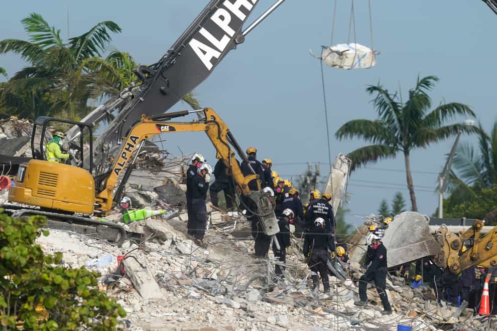 Rescue crews work at the site of the collapsed Champlain Towers in Florida (Lynne Sladky/AP)