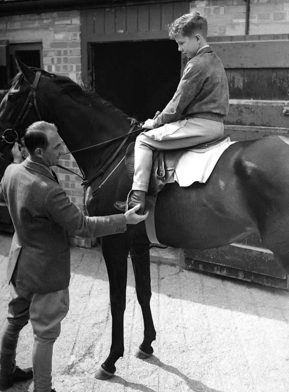 Lester Piggott, age 12, sitting on a horse at his fathers stables at Lambourn (PA)