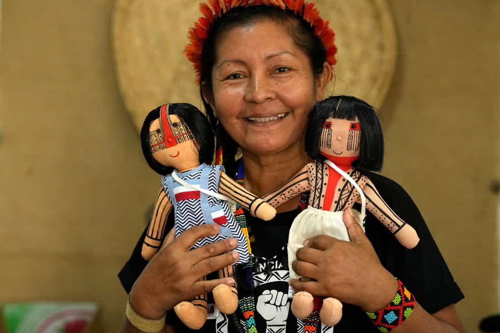 Luakam Anambe, of Brazil’s Anambe indigenous group, who is at the helm of a small, burgeoning business selling handmade indigenous dolls poses for a photo in her sewing workshop at her home in Rio de Janeiro, Brazil, Tuesday, May 24, 2022. Part of the money she makes from her dolls goes toward a social project Luakam has been putting together in Para state, to help women in need (Silvia Izquierdo/AP)