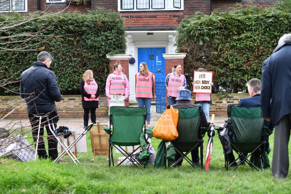 Pro-choice demonstrators (back) and anti-abortion demonstrators (foreground) gather outside a Marie Stopes clinic in London (John Stillwell/PA)