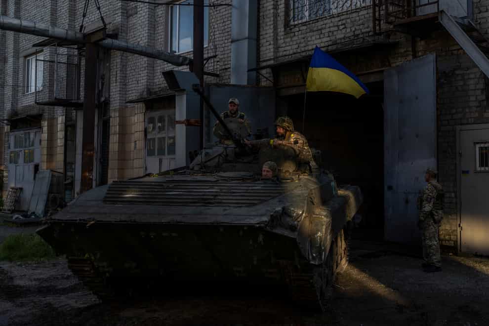 Ukrainian servicemen park a Russian infantry combat vehicle in the Kharkiv area (Bernat Armangue/AP)