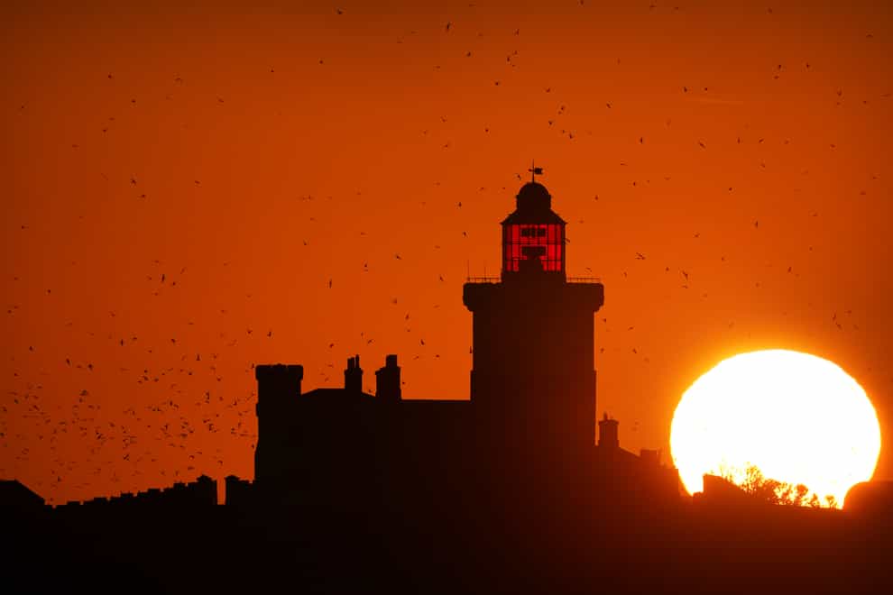 The sun rises over Coquet Island in May (Owen Humphreys/PA)