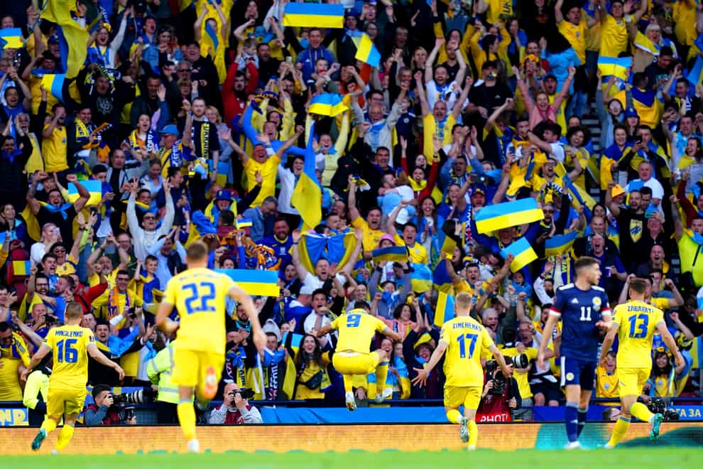Roman Yaremchuk (centre) celebrates in front of the Ukraine fans after doubling their lead (Jane Barlow/PA)