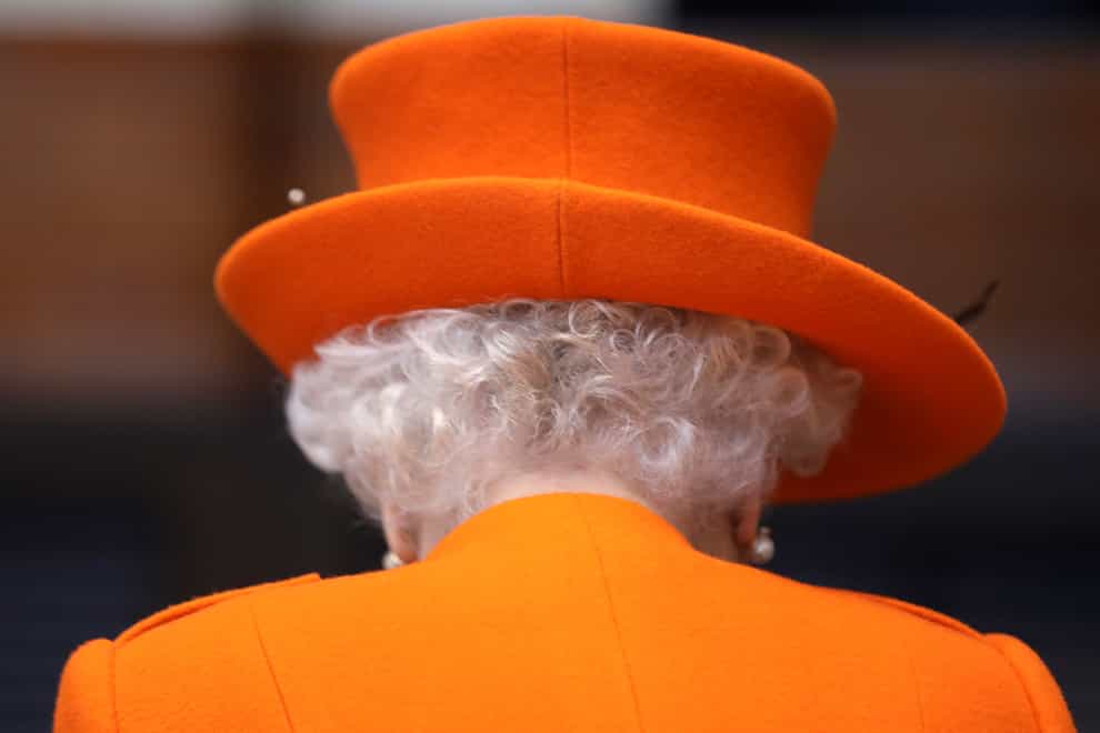 The Queen in one of her trademark vibrant matching hats and coats (Simon Dawson/PA)