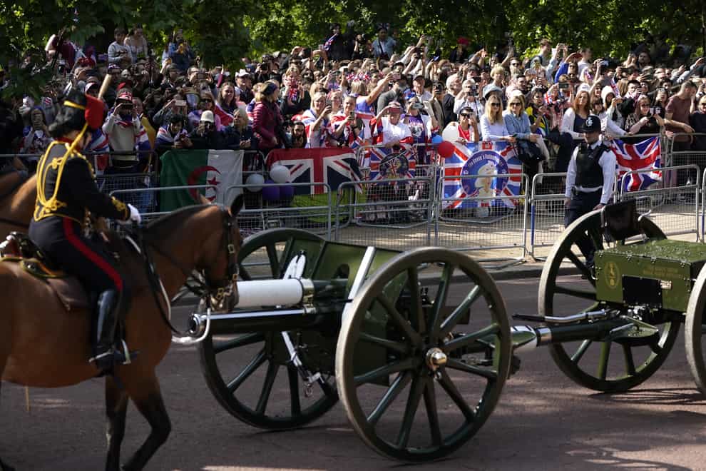 Royal fans watch as the Royal Procession heads to the Trooping the Colour ceremony at Horse Guards Parade, central London. (PA/Andrew Matthews)