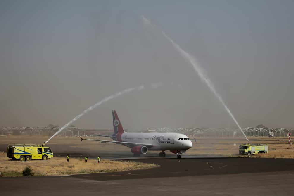 A Yemen Airways plane, the first commercial flight in six years from Yemen’s rebel-held capital is greeted with a water spray salute at the Sanaa international airport (AP)